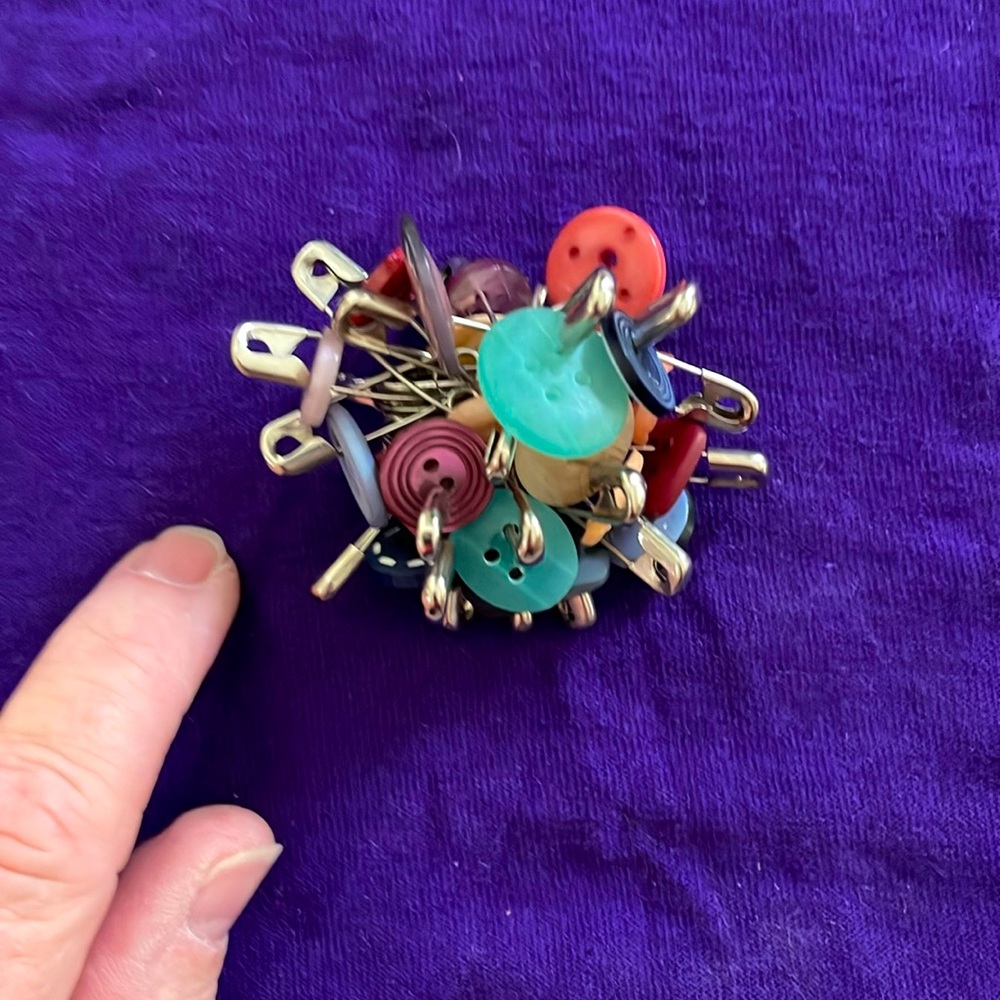Handmade jewelry pin with multi colored buttons & safety pins!
